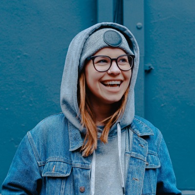 Icon of woman with redish/blond hair in a navy hoody